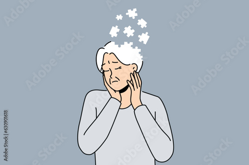 Elderly woman suffers from dementia and memory loss and is in need of specialized caregivers. Sad female pensioner is sick with dementia due to advancing age or lot of psychological stress in youth