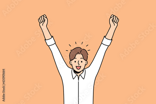 Delighted man celebrates victory by raising hands up and rejoicing in career achievements or end working day. Business man shouts with smile and is delighted with amazing news promising income growth