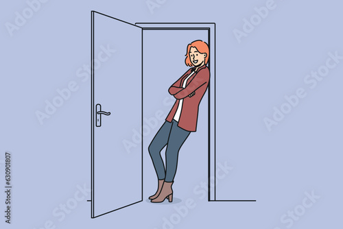 Cheerful woman stands in doorway with arms crossed and saying goodbye to guests. Girl is in doorway and looks at screen with smile, for concept of hospitality and friendship between neighbors