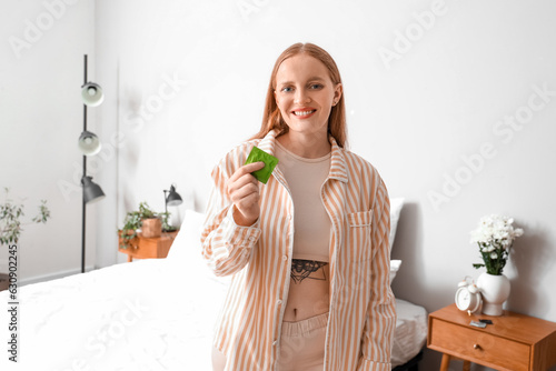 Young woman with condom in ...