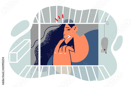 Hungry woman looks into empty refrigerator and is surprised at lack of food and dead mouse