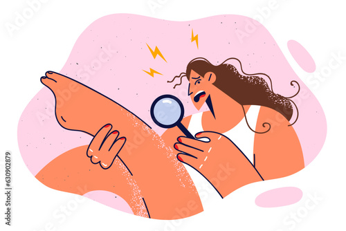 Woman in need of epilation uses magnifying glass and frightenedly examines leg in search of hair