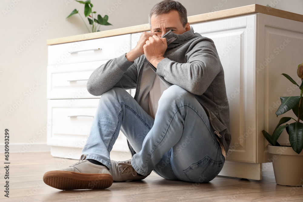 Mature man having panic attack in kitchen Mature man having panic attack in kitchen