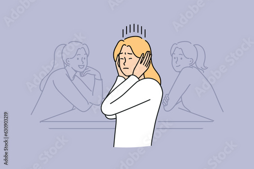 Woman covers ears by refusing to listen to statements of toxic colleagues and ignoring criticism when performing professional tasks. Girl office worker sits at table ignoring words of others