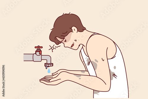 Emaciated guy near faucet with dripping water is trying to survive during drought and wash or saved from thirst. Problem of drought and lack of access to fresh water causing ecological disaster