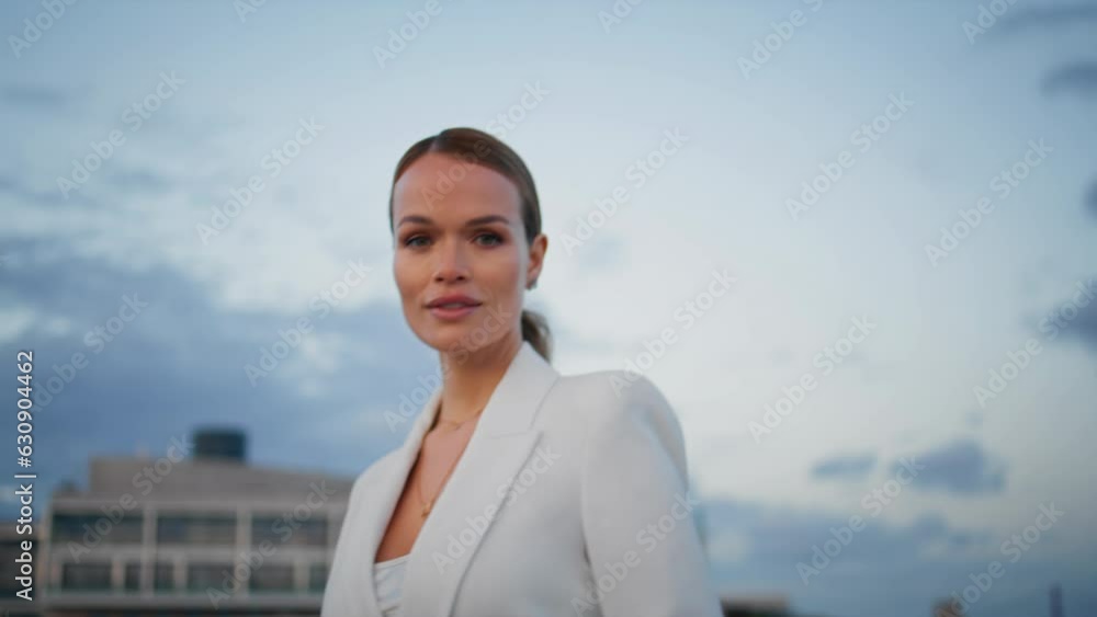 Walking businesswoman looking camera enjoying cloudy evening weather close up. Walking businesswoman looking camera enjoying cloudy evening weather close up.