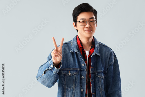 Young Asian man showing two...