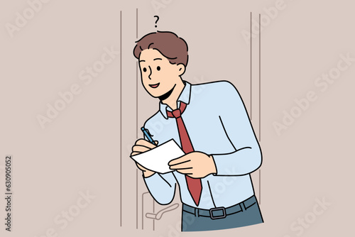 Man eavesdrops on business secrets standing near office door and writing insider information at paper. Guy is spying on boss and trying to get hold of insider data of company or corporation