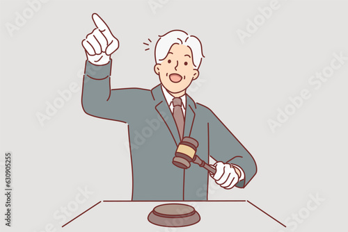 Man auctioneer holds wooden mallet and points finger at potential buyer named lowest price for item