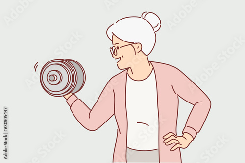 Strong grandmother lifts dumbbell wishing to remain powerful and energetic after retirement
