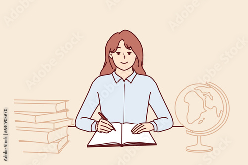 Teenager girl sits at school desk with globe and books to gain new knowledge and quality education. Schoolgirl studying in elementary school is happy to do homework given by teacher in geography