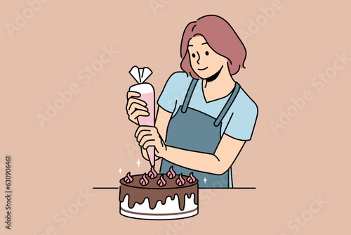 Woman confectioner prepares delicious cake for birthday party and decorates dessert with chocolate and butter cream. Young girl uses pastry bag to prepare sweet cake for festive table.