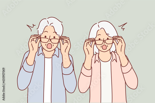 Elderly surprised couple takes off glasses and looks at screen after learning about big promotions 
