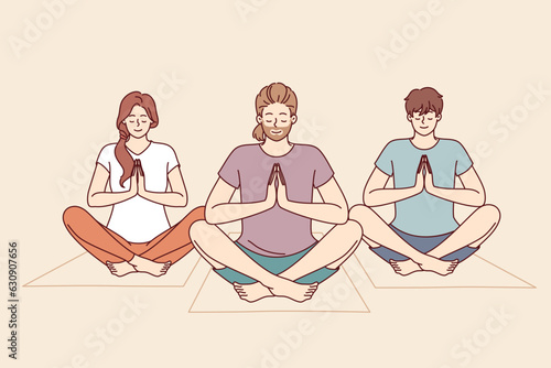 People do meditation and yoga sitting on fitness mats and taking lotus position to do zen practice. Friends meditate and do yoga to cleanse soul and improve mental state after difficult life period.
