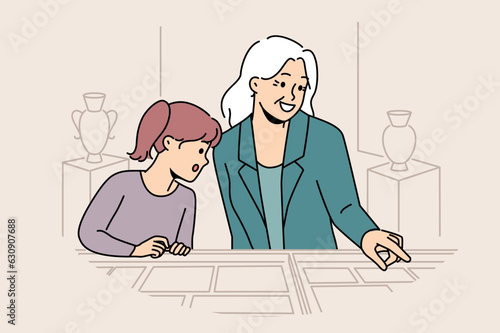 Little girl visits museum with grandmother and looks at antique exhibits found by archaeologists. Curator of museum conducts tour for child interested in history and ancient artifacts