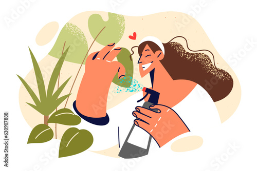 Woman caring for houseplants by spraying petals with water and fertilizer for cultivating vegetation