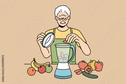 Elderly man uses blender and prepares smoothies from fresh fruits and vegetables in order to stay healthy. Retired man prepares smoothies and follows vitamin diet prescribed by nutritionist doctor