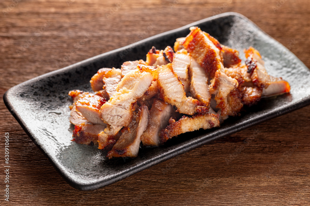 tasty slice fried pork in rectangular ceramic plate on rustic natural wood texture background