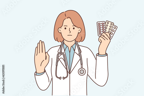 Woman doctor with pills shows stop gesture urging to stop taking antibiotics or antidepressants