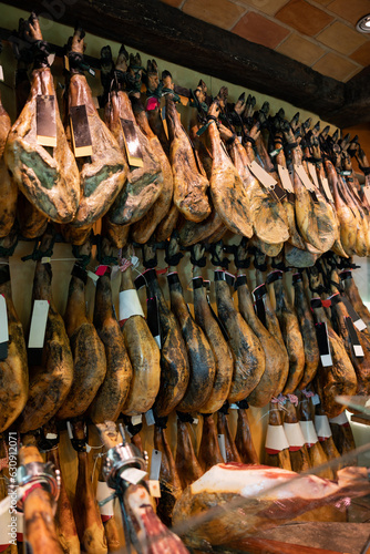 Legs of traditional Spanish jamon ready for sale in grocery