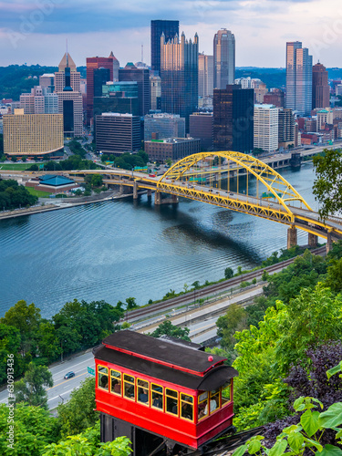 Red car of Duquesne Incline with Pittsburgh downtown panorama on background at sunset photo