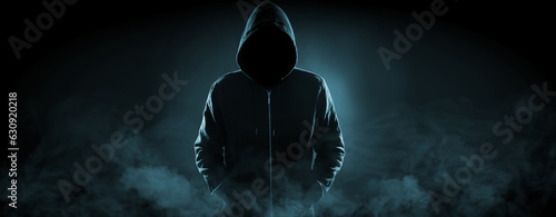 Anonymous man in hood surrounded by smoke on black background. Banner design
