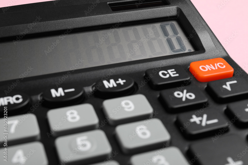Calculator on pink background, closeup. Office stationery Calculator on pink background, closeup. Office stationery
