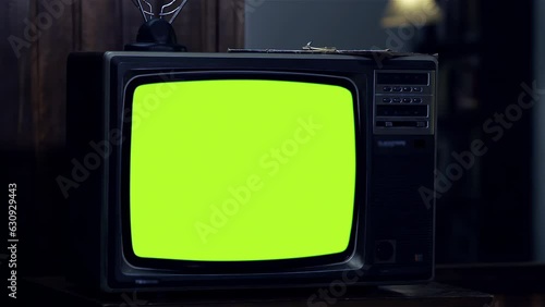 Old TV Turning On Green Screen with Static Noise During the Night. Close Up. You can replace green screen with the footage or picture you want with “Keying” effect in After FXs. 4K Resolution. photo