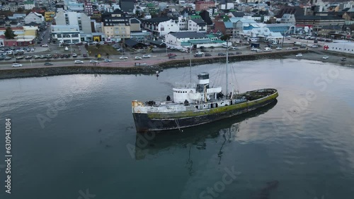 Aerial view of a stranded ship with a city in the background photo