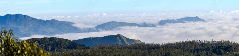 Beautiful panoramic landscape photograph of the mountain range above the white clouds in the Central highlands of Sri Lanka.