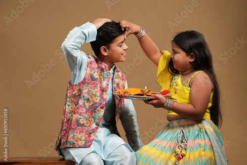 Indian asian cute little kids celebrating Raksha Bandhan,Bhai Dooj