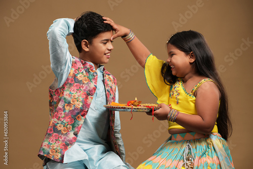 Indian asian cute little kids celebrating Raksha Bandhan,Bhai Dooj