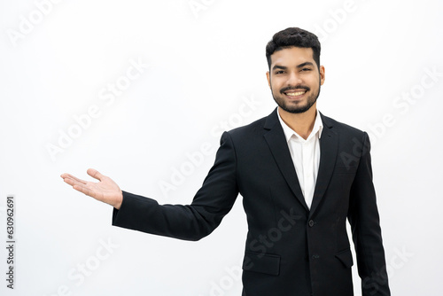 Pointing finger to blank space. Happy Young asian businessman on isolated white background. Handsome businessman in office suit uniform.