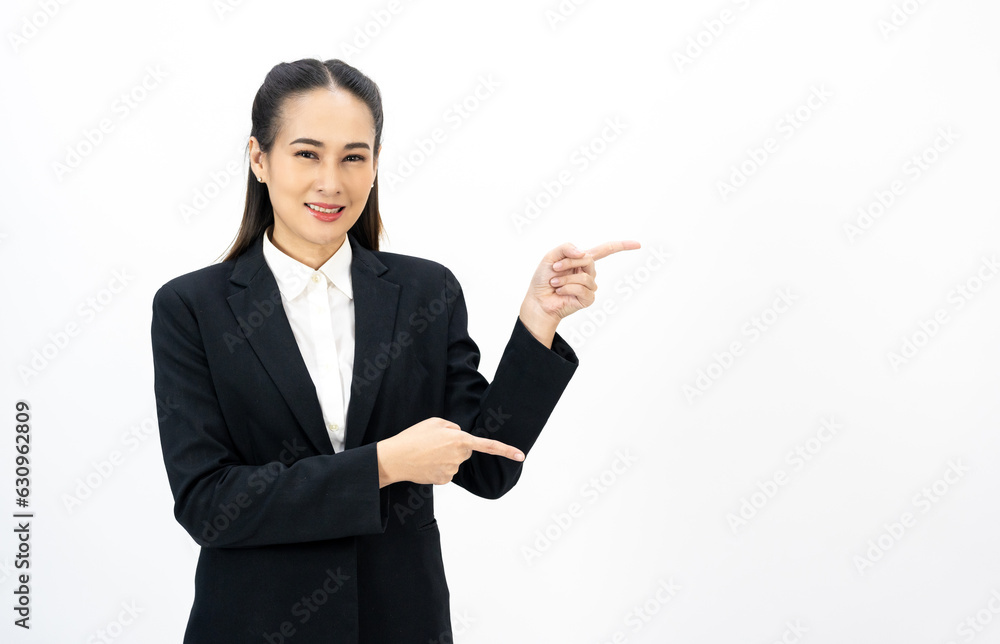 Young asian business woman happy smiling pointing finger to blank space on isolated white background. Female around 25 in suit portrait shot in studio. Young asian business woman happy smiling pointing finger to blank space on isolated white background. Female around 25 in suit portrait shot in studio.