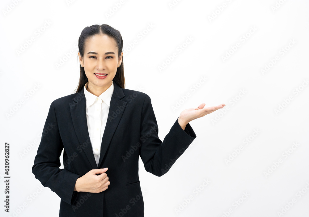 Young asian business woman happy smiling pointing finger to blank space on isolated white background. Female around 25 in suit portrait shot in studio. Young asian business woman happy smiling pointing finger to blank space on isolated white background. Female around 25 in suit portrait shot in studio.