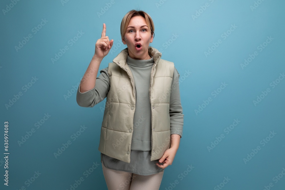 blonde successful young woman reporting news on isolated blue background with copy space blonde successful young woman reporting news on isolated blue background with copy space