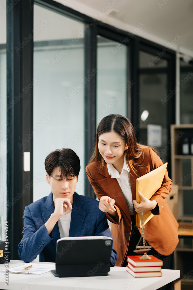 Asian business team and lawyers discussing contract papers sitting at the table. Concepts of law, advice, legal services. at office Asian business team and lawyers discussing contract papers sitting at the table. Concepts of law, advice, legal services. at office