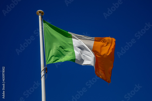 irish flag ireland country flag on top of the mast in the wind and blue sky photo