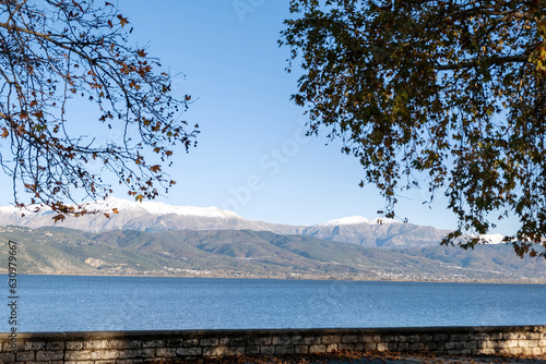 Wallpaper Mural Ioannina city Pamvotis Lake Epirus Greece. Blue water and sky forest, snowy mountain peak winter day Torontodigital.ca
