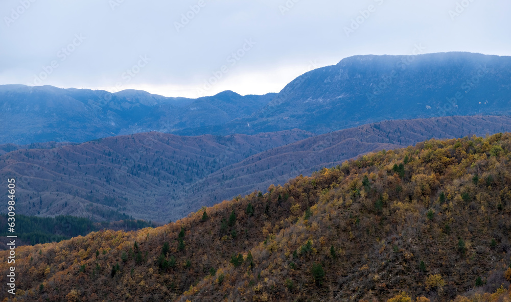 Greece Pindos misty mountain range. Panoramic view of mountain formation, snowy peak of Pindus.