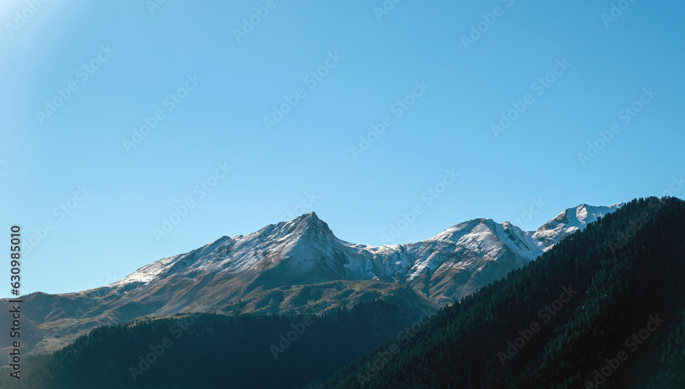 Pindos mountain range Greece. Snowy peak of Pindus misty mountain, forest blue sky background, space
