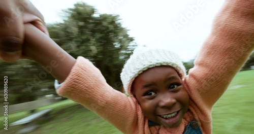 Child, play or hands of parent spinning in circle movement for quality bonding time in park. Family game, happy or pov of father swinging on grass lawn with an African kid, smile or freedom outdoors photo