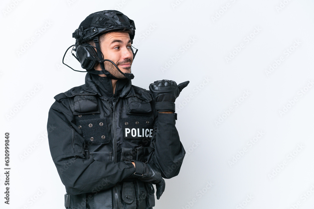 Young caucasian SWAT man isolated on white background pointing to the side to present a product Young caucasian SWAT man isolated on white background pointing to the side to present a product