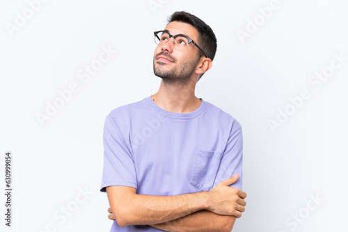 Young caucasian man isolated on white background looking to the side