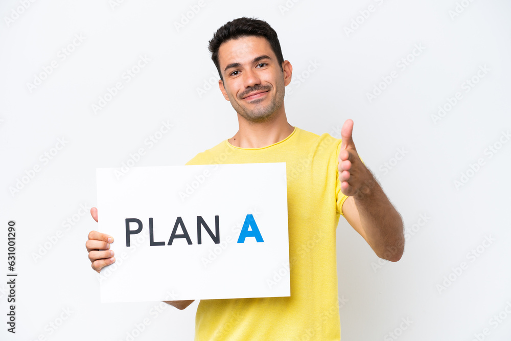 Young handsome man over isolated white background holding a placard with the message PLAN A making a deal Young handsome man over isolated white background holding a placard with the message PLAN A making a deal