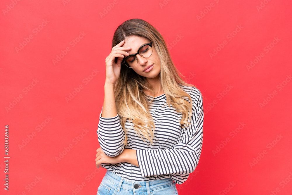 Young Uruguayan woman isolated on red background with headache Young Uruguayan woman isolated on red background with headache