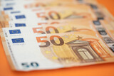 50 euro bills on an orange background