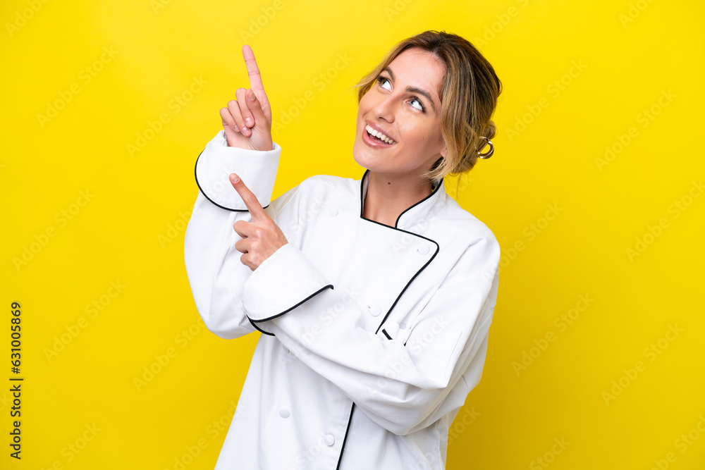 Uruguayan chef woman isolated on yellow background pointing with the index finger a great idea Uruguayan chef woman isolated on yellow background pointing with the index finger a great idea