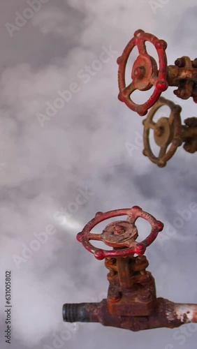 vertical video. Broken steam valve is leaking steam from between its gasket