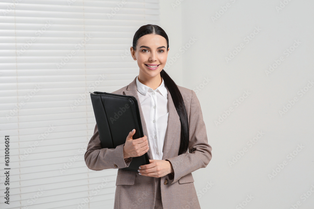Beautiful real estate agent with documents indoors Beautiful real estate agent with documents indoors